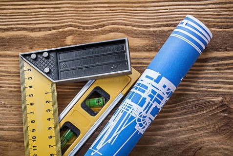 Blue construction drawing level square ruler on wooden board