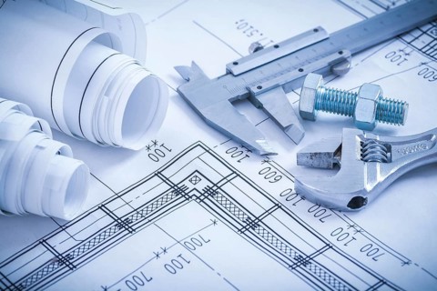 Screw bolt with nut adjustable spanner slide caliper rolls of construction plans on blueprint