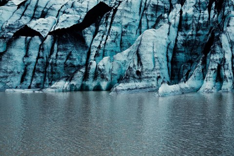 Blue glacier wall with striped pattern reflected on calm water, iceberg Iceland, glacier, snow, ice