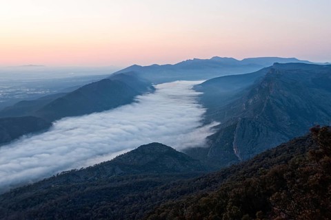 Clouds in the valley and the Wonderland Range at sunrise photographed from the Boroka Lookout in