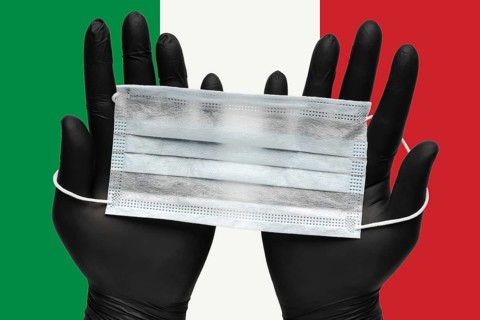 Doctor holds face mask in hands in black medical gloves on background colors flag of Italy or