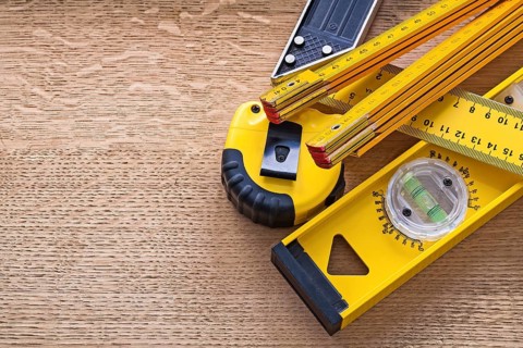 Wood oaken board with yellow objects of measurement construction concept