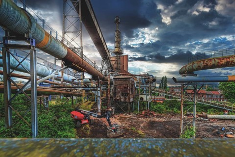 Complex industrial plant with rusted pipes and dilapidated building under a cloudy sky, HF6, Lost