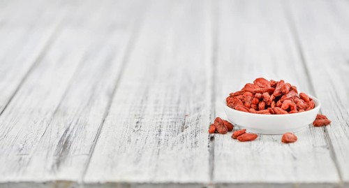 Fresh made Dried Goji Berries on a vintage background (close-up shot)