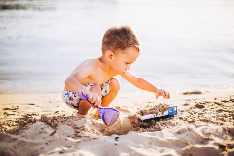 Kids Play On Beach. Sand And Water Toy. Truck toy car with sand and soil. green environment