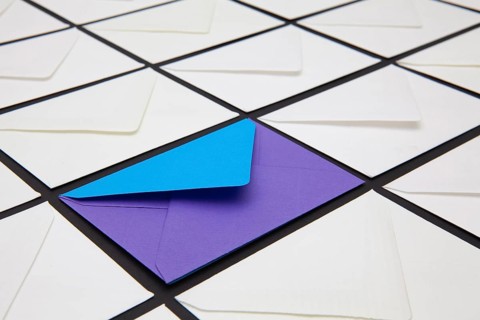 Composition with white and colored envelopes on the table. The photo suitable for various holidays