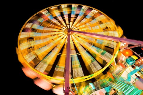 Turning illuminated ferris wheel shot at long exposure