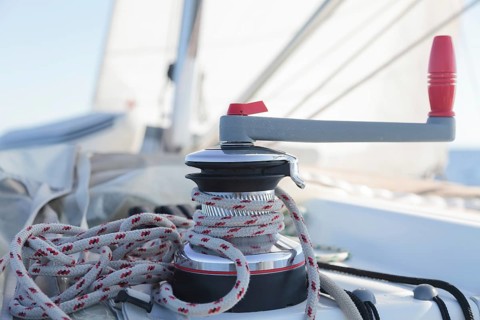 Winch with rope on sailing boat in the sea