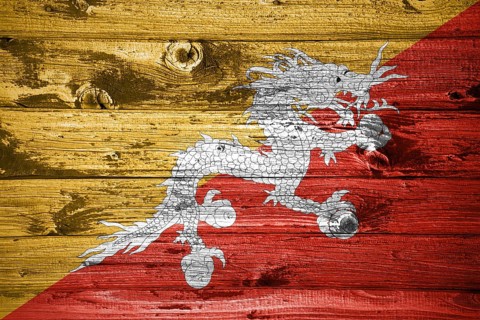 Bhutan flag on wooden planks background wood flag