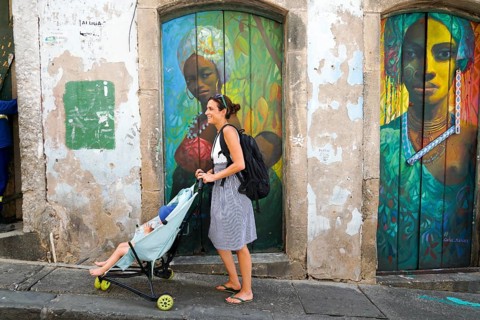 Tourist walking in the colorful historic district of Pelourinho, Bahia, Brazil. Historic
