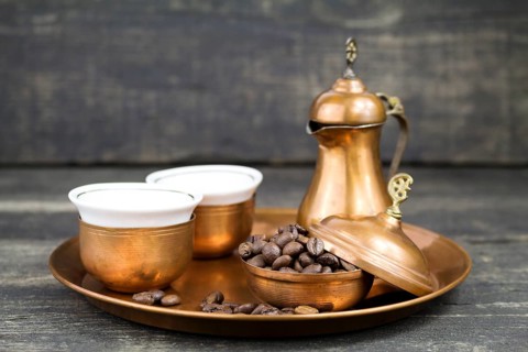 Turkish coffee with traditional copper serving set and coffee beans