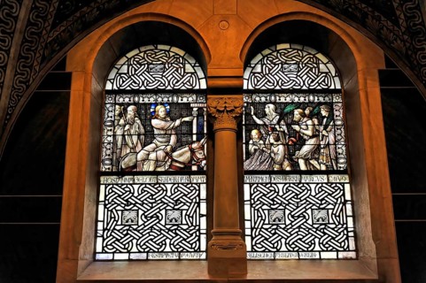 Stained glass window with sacred scenes and filigree stained glass in a church wall, Bad Homburg v.