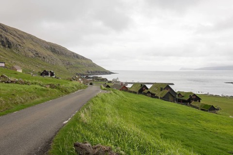 Kirkjubøur on the Faroe Islands with typical houses, church and road, Kirkjubøur, Faroe Islands,