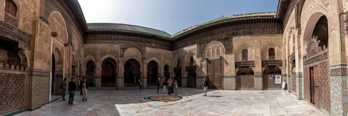 Fes, Morocco, April 05, 2023, Traditional oriental facade at the courtyard of madrasa Bou Inaniya