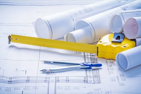 Tapeline compass rolls of blueprints
