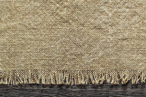 Vintage sacking fabric on wooden board
