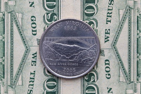 A quarter of West Virginia on US dollar bills. Symmetric composition of US dollar bills and a