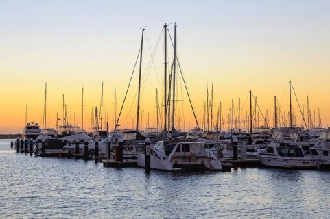 Sunset over the Hillarys marina full of mooring boats, Perth, WA, Australia
