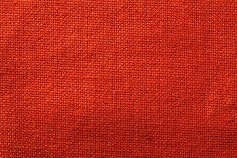 Cotton textile background. Red closeup textile texture