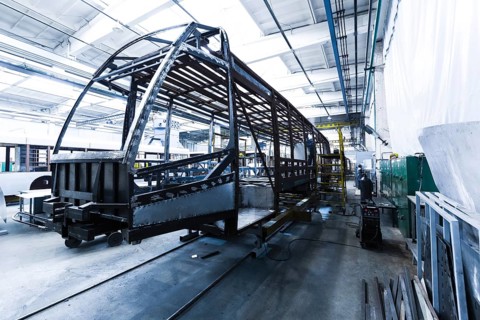 One working day of modern automatic bus trolleybus car production with unfinished cars workers in