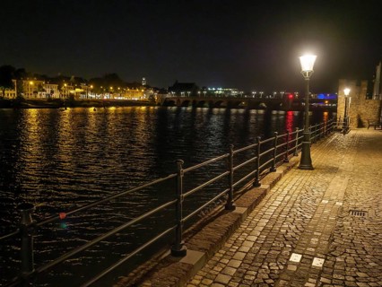 River course at night, illuminated by lights and reflecting water surface, maastricht, the