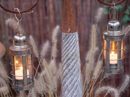 Rustic metal lanterns with burning candles that provide a warm source of light, weseke,