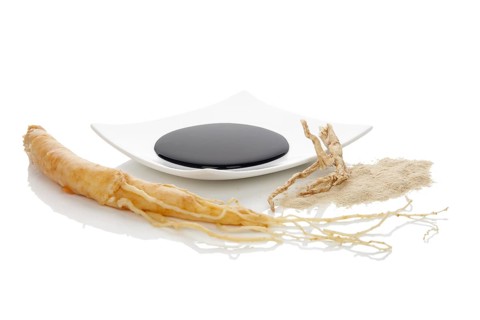 Pure ginseng powder and extract with ginseng root, isolated on white background. Korean ginseng.