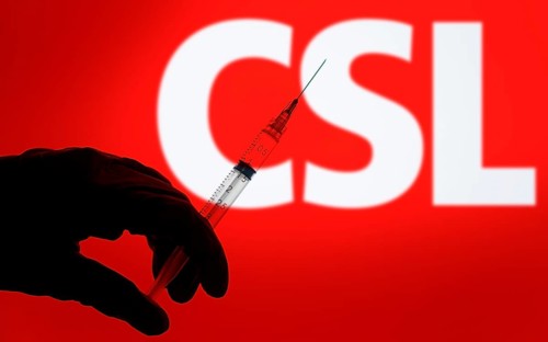 A gloved hand holding a syringe in front of the CSL logo. CSL Limited is an Australian