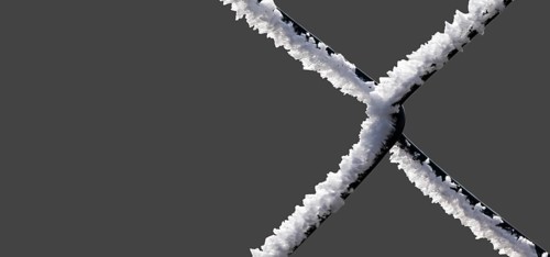 A chain-link fence with hoarfrost