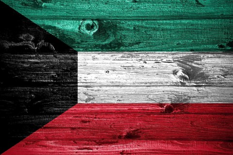 Kuwait flag on wooden planks background wood flag