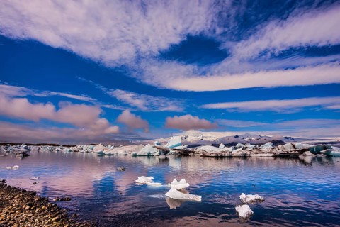 The concept of northern extreme tourism. The ice floes and cirrocumulus clouds of lagoon