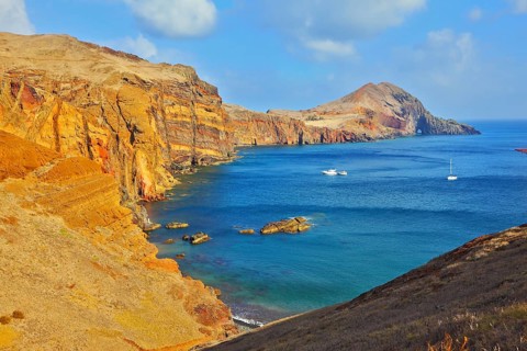 White yachts lit sunset. Quiet ocean cove on the island of Madeira. Calm on the Atlantic Ocean