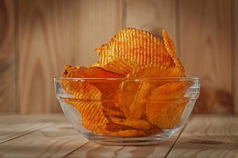 Transparent Glass Bowl Of Potato Chips With Paprika