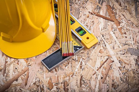 Square ruler construction level wooden meter hard hat on chipboard