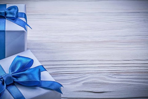 Set of wrapped present boxes on wooden board copy space celebrations concept