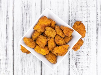 Homemade Chicken Nuggets on vintage background (selective focus, close-up shot)