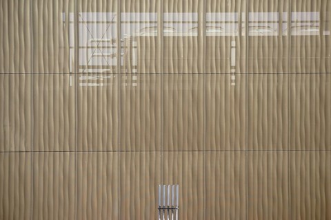 The outer façade of a combined heat and power plant made of perforated metal panels behind which