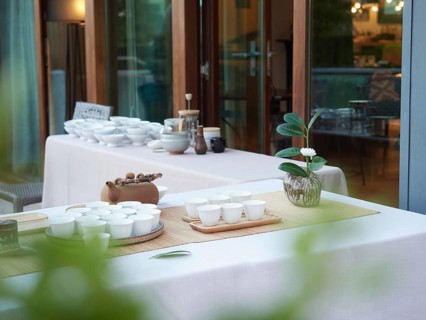 Elegant break at events. Tables with outdoor tea service, teapot and white cups