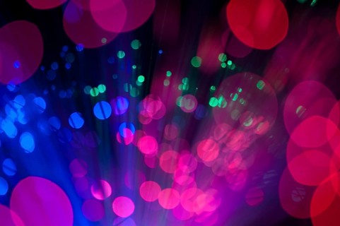 Blue and pink festive lights and circles background. Blurred christmas lights