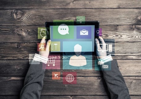 Top view of woman in business suit sitting at wooden table with tablet pc