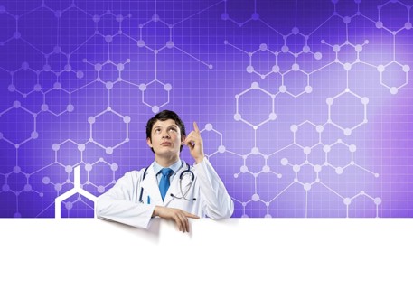 Young handsome doctor holding white blank banner. Place your text
