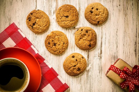 Cup of coffee and cookies on rustic wooden table