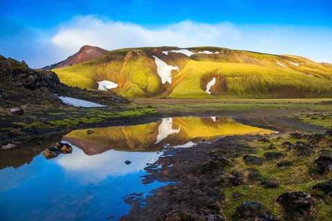 Light golden dawn illuminates the mountains and glaciers national park Landmannalaugar. The sunrise