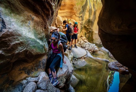 Walkers dodging waterlogged stretches, Torrent de Pareis, Sa Calobra, Majorca, Balearic Islands,