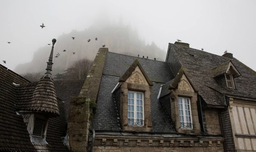Mont-Saint-Michel, monastery hill, Grand Rue, roofscape above the abbey in the mist