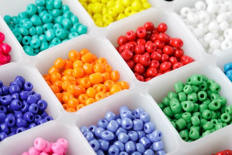 Close up multi colored beads heap in box