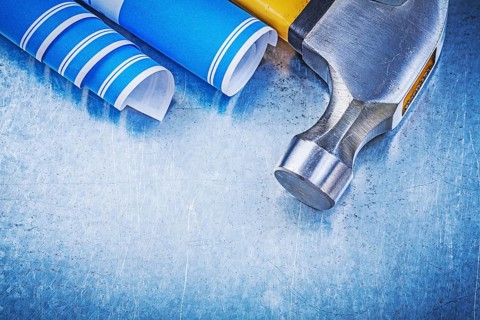 Blue blueprints claw hammer on metallic background