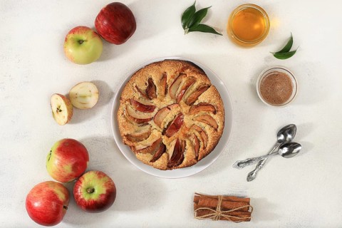 Kitchen background with apple pie, honey, apples, spices, cozy warm concept, hello autumn, hygge