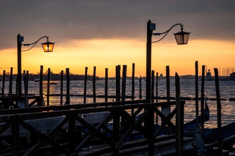 Morning atmosphere at sunrise, gondola jetty, lanterns, Venice, Italy
