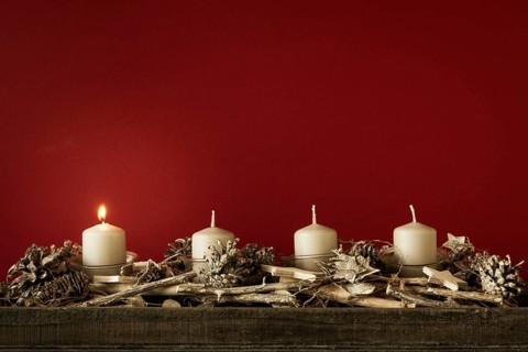 Advent time one candles burning with red background for your content